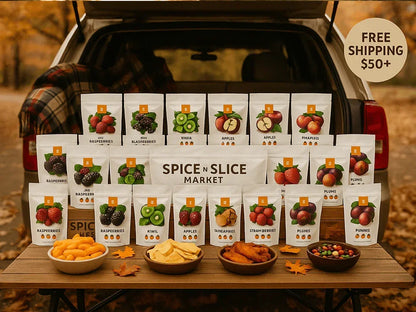 Spice n Slice Market variety of dried fruit snacks displayed on picnic table outdoors with fall leaves and free shipping $50+ sign